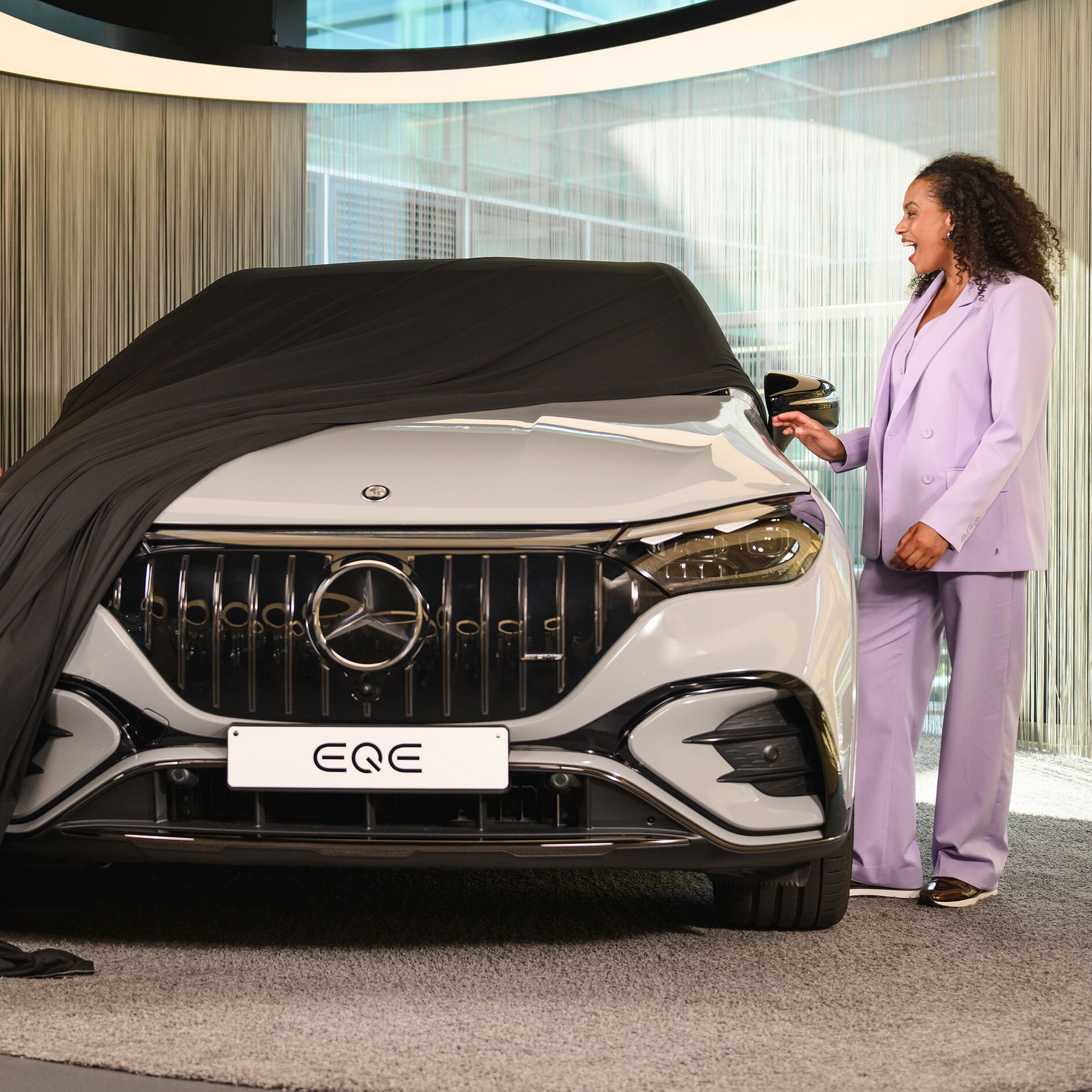 Own your Mercedes- Benz with confidence. A person unveiling their new Mercedes-Benz.